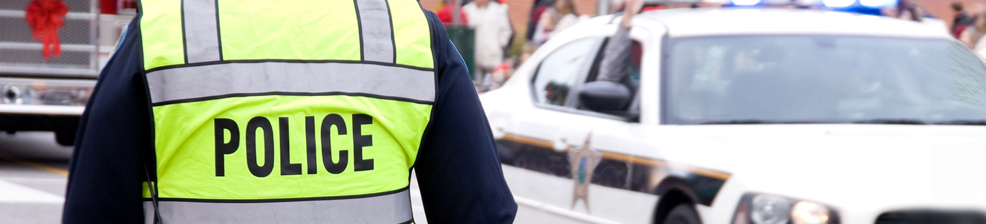 A police officer wearing a high-visibility vest with 