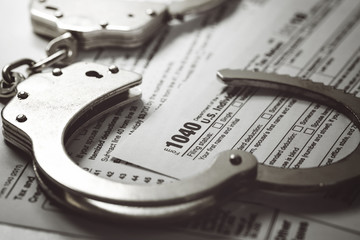 tax form and handcuffs