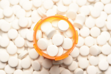 white pills in orange container