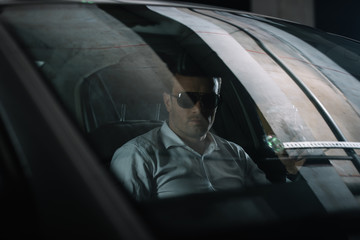 man in sunglasses in a car