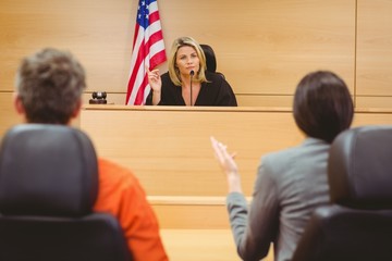 judge with criminal and lawyer at hearing