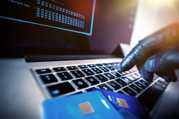 computer keyboard and hands with gloves and credit cards