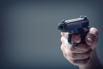 person's hand holding gun